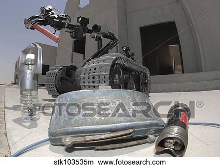 A Talon 3B robot recovering a stick of dynamite and other explosive devices in Bahrain. View Large Photo Image Picture - A Talon 3B robot recovering a stick of dynamite and other explosive devices in Bahrain.. Fotosearch