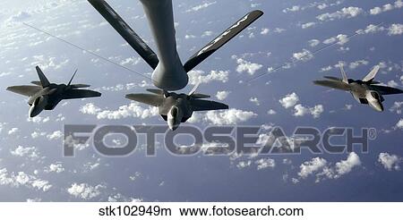 A three ship formation of F-22 Raptors move into refueling position. View Large Photo Image Picture - A three ship formation of F-22 Raptors move into refueling position.. Fotosearch