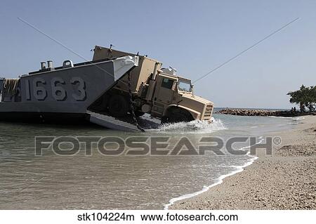 A truck offloads from a landing craft unit. View Large Photo Image Picture - A truck offloads from a landing craft unit.. Fotosearch