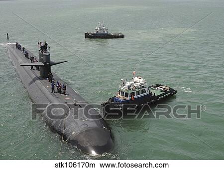 A tugboat guides attack submarine USS Bremerton to shore. View Large Photo Image Picture - A tugboat guides attack submarine USS Bremerton to shore.. Fotosearch