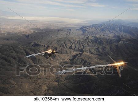 Picture - A two-ship of B-1B Lancers release chaff and flares while maneuvering over New Mexico.. Fotosearch