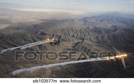 A two ship of B-1B Lancers release chaff and flares while maneuvering over New Mexico. View Large Photo Image Picture - A two ship of B-1B Lancers release chaff and flares while maneuvering over New Mexico.. Fotosearch