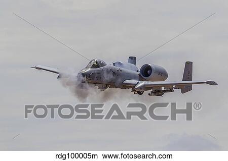 A U. S. Air Force A-10 Thunderbolt II fires its 30mm cannon. View Large Photo Image Picture - A U. S. Air Force A-10 Thunderbolt II fires its 30mm cannon.. Fotosearch