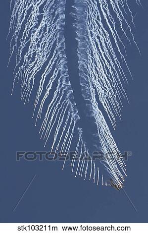 A U. S. Air Force AC-130 Gunship aircraft executing an evasive maneuver and dropping chaff and flares. View Large Photo Image Picture - A U. S. Air Force AC-130 Gunship aircraft executing an evasive maneuver and dropping chaff and flares.. Fotosearch
