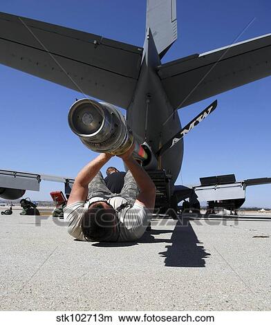 Picture - A U. S. Air Force Airman lifts the boom of a KC-135 Stratotanker.. Fotosearch