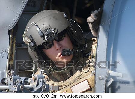 A U. S. Air Force Airman peers out the side of a HH-60 Pave Hawk. View Large Photo Image Picture - A U. S. Air Force Airman peers out the side of a HH-60 Pave Hawk.. Fotosearch