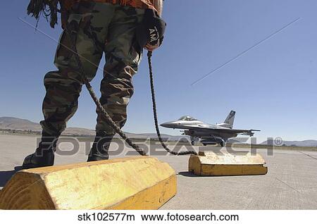 A U. S. Air Force crew chief waits to chalk the flight of an aircraft. View Large Photo Image Picture - A U. S. Air Force crew chief waits to chalk the flight of an aircraft.. Fotosearch