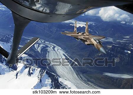 A U. S. Air Force F-15C Eagle positioning itself behind a KC-135R Stratotanker over Alaska. View Large Photo Image Picture - A U. S. Air Force F-15C Eagle positioning itself behind a KC-135R Stratotanker over Alaska.. Fotosearch
