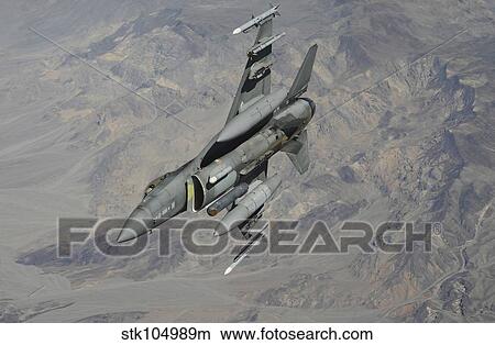 A U. S. Air Force F-16 Fighting Falcon flies over Nevada. View Large Photo Image Picture - A U. S. Air Force F-16 Fighting Falcon flies over Nevada.. Fotosearch