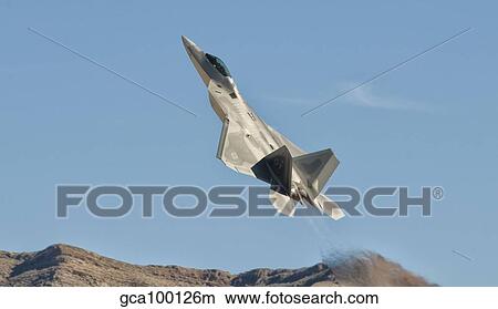 A U. S. Air Force F-22 Raptor takes off from Nellis Air Force Base, Nevada. View Large Photo Image Picture - A U. S. Air Force F-22 Raptor takes off from Nellis Air Force Base, Nevada.. Fotosearch