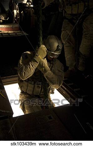 Picture - A U. S. Air Force pararescueman begins his descent from the belly of a CH-53E Super Stallion.. Fotosearch
