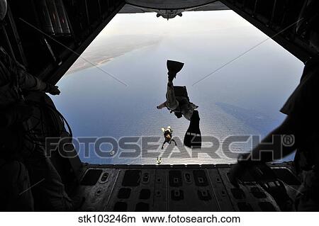 A U. S. Air Force pararescueman jumping out of an HC-130P Hercules aircraft. View Large Photo Image Picture - A U. S. Air Force pararescueman jumping out of an HC-130P Hercules aircraft.. Fotosearch