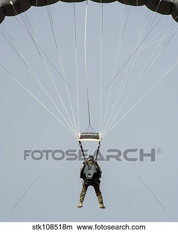 A U. S. Air Force pararescueman descends during jump training. View Large Photo Image Picture - A U. S. Air Force pararescueman descends during jump training.. Fotosearch