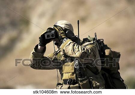 Picture - A U. S. Air Force Special Tactics Combat Controller uses a laser rangefinder.. Fotosearch