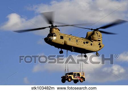 A U. S. Army CH-47 Chinook helicopter transports a Humvee. View Large Photo Image Picture - A U. S. Army CH-47 Chinook helicopter transports a Humvee.. Fotosearch