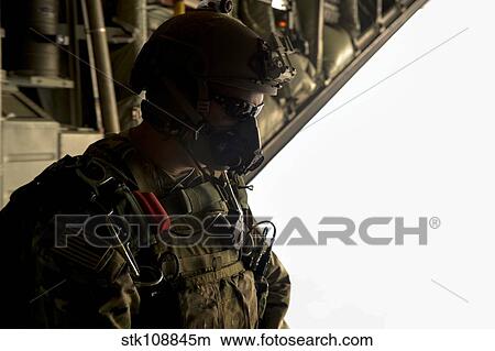 A U. S. Army Green Beret waits to jump out of a C-130H3 Hercules. View Large Photo Image Picture - A U. S. Army Green Beret waits to jump out of a C-130H3 Hercules.. Fotosearch