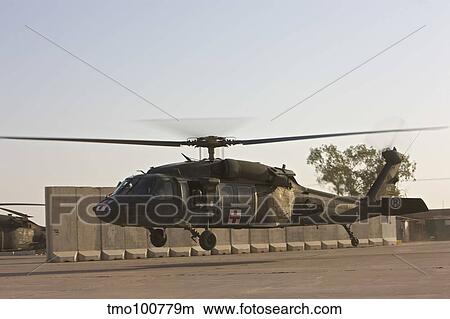 A U. S. Army medevac UH-60 Black Hawk takes off from Camp Speicher. View Large Photo Image Picture - A U. S. Army medevac UH-60 Black Hawk takes off from Camp Speicher.. Fotosearch