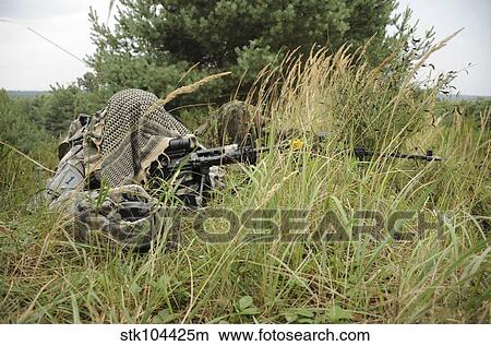 A U. S. Army Soldier and a German Bundeswehr soldier camouflage themselves. View Large Photo Image Picture - A U. S. Army Soldier and a German Bundeswehr soldier camouflage themselves.. Fotosearch
