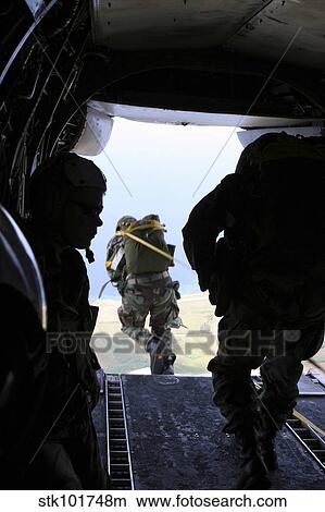 A U. S. Army Soldier performs a static-line jump from a CH-46E Sea Knight. View Large Photo Image Picture - A U. S. Army Soldier performs a static-line jump from a CH-46E Sea Knight.. Fotosearch