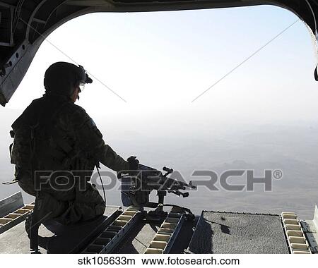 A U. S. Army soldier scans the area in the back of a CH-47 Chinook over Afghanistan. View Large Photo Image Picture - A U. S. Army soldier scans the area in the back of a CH-47 Chinook over Afghanistan.. Fotosearch