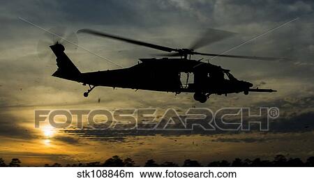A U. S. Army UH-60 Black Hawk leaves the drop zone. View Large Photo Image Picture - A U. S. Army UH-60 Black Hawk leaves the drop zone.. Fotosearch