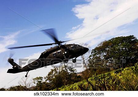 A U. S. Army UH-60 Black Hawk helicopter flies out of an emergency landing zone. View Large Photo Image Picture - A U. S. Army UH-60 Black Hawk helicopter flies out of an emergency landing zone.. Fotosearch
