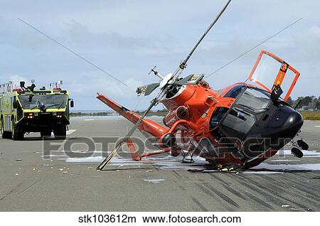 A U. S. Coast Guard MH-65 Dolphin helicopter lays on its side after it crashed at the Arcata Airport during a training mission. View Large Photo Image Picture - A U. S. Coast Guard MH-65 Dolphin helicopter lays on its side after it crashed at the Arcata Airport during a training mission.. Fotosearch