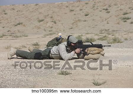 A U. S. Contractor sights in a German G36 assault rifle. View Large Photo Image Picture - A U. S. Contractor sights in a German G36 assault rifle.. Fotosearch