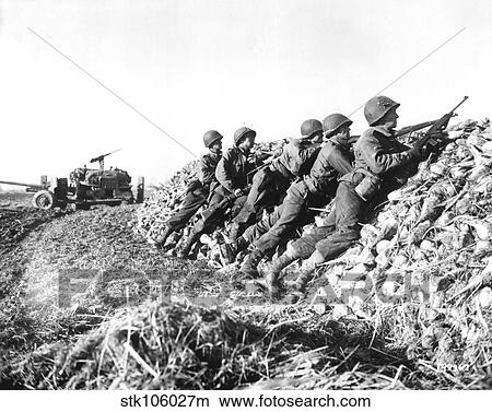 A U. S. Infantry anti-tank crew fires on Nazis somewhere in Holland. View Large Photo Image Picture - A U. S. Infantry anti-tank crew fires on Nazis somewhere in Holland.. Fotosearch