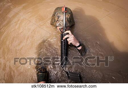 A U. S. Marine Corps back crawls through an obstacle. View Large Photo Image Picture - A U. S. Marine Corps back crawls through an obstacle.. Fotosearch