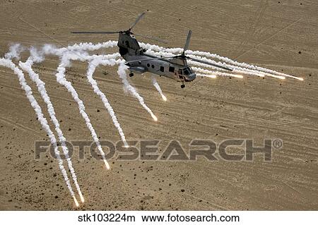 A U. S. Marine Corps CH-46 Sea Knight helicopter launching flares over the desert near Al Taqqadum, Iraq. View Large Photo Image Picture - A U. S. Marine Corps CH-46 Sea Knight helicopter launching flares over the desert near Al Taqqadum, Iraq. . Fotosearch