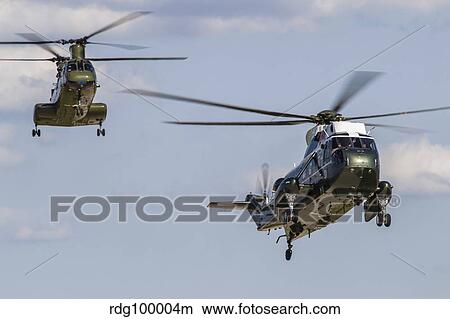 A U. S. Marine Corps VH-3D transport helicopter with a CH-46E Sea Knight behind. View Large Photo Image Picture - A U. S. Marine Corps VH-3D transport helicopter with a CH-46E Sea Knight behind.. Fotosearch