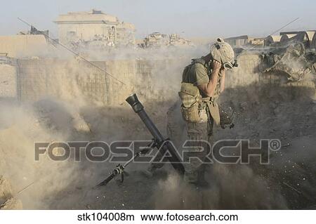Picture - A U. S. Marine fires a mortar round during combat operations in Afghanistan.. Fotosearch