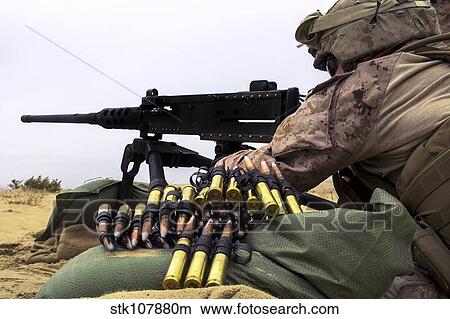 A U. S. Marine fires an M2. 50 caliber machine gun. View Large Photo Image Picture - A U. S. Marine fires an M2. 50 caliber machine gun.. Fotosearch