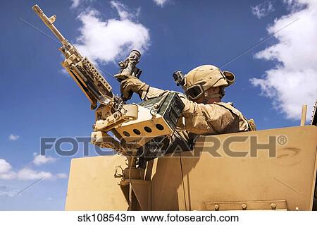 A U. S. Marine inspects his weapon. View Large Photo Image Picture - A U. S. Marine inspects his weapon.. Fotosearch