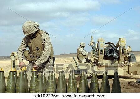 A U. S. Marine prepares howitzer rounds to be fired near Baghdad, Iraq. View Large Photo Image Picture - A U. S. Marine prepares howitzer rounds to be fired near Baghdad, Iraq.. Fotosearch