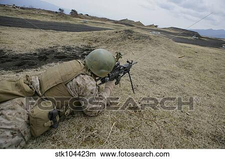 Picture - A U. S. Marine provides suppressive fire during a squad-assault training event.. Fotosearch