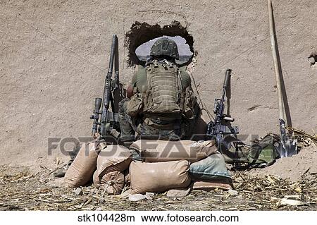 A U. S. Marine sniper observes his sector at a patrol base near Sangin, Afghanistan. View Large Photo Image Picture - A U. S. Marine sniper observes his sector at a patrol base near Sangin, Afghanistan.. Fotosearch