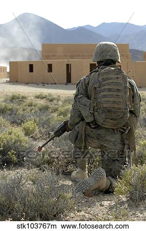 A U. S. Marine watches for simulated insurgents in a military operation on urban terrain. View Large Photo Image Picture - A U. S. Marine watches for simulated insurgents in a military operation on urban terrain.. Fotosearch