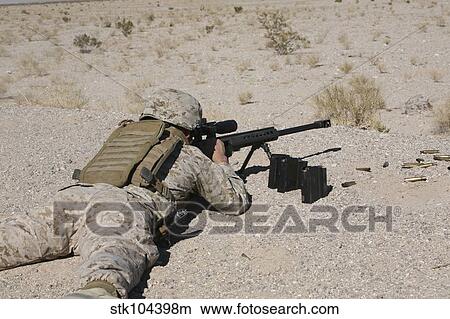 Picture - A U. S. Marine zeros his M107 sniper rifle.. Fotosearch