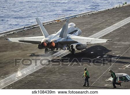 A U. S. Navy F/A-18C Hornet launches from the flight deck of USS Nimitz. View Large Photo Image Picture - A U. S. Navy F/A-18C Hornet launches from the flight deck of USS Nimitz.. Fotosearch