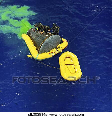 A U. S. Navy frogman team helps in the recovery of the Gemini-Titan 4 spacecraft. View Large Photo Image Stock Photograph - A U. S. Navy frogman team helps in the recovery of the Gemini-Titan 4 spacecraft.. Fotosearch