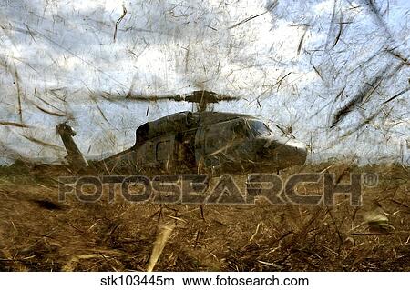 A U. S. Navy HH-60 Seahawk stirs up debris while taking off. View Large Photo Image Picture - A U. S. Navy HH-60 Seahawk stirs up debris while taking off.. Fotosearch