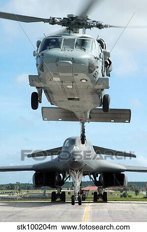 Picture - A U. S. Navy MH-60S Seahawk helicopter and a U. S. Air Force B-1B Lancer bomber.. Fotosearch