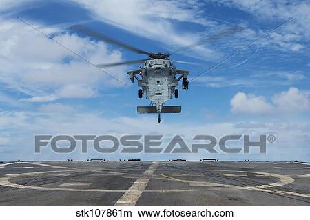 A U. S. Navy MH-60S Seahawk helicopter prepares to land. View Large Photo Image Picture - A U. S. Navy MH-60S Seahawk helicopter prepares to land.. Fotosearch