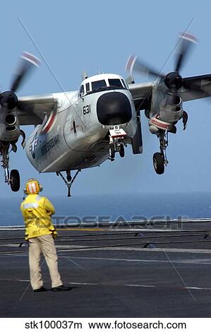 A U. S. Navy officer observes a C-2A Greyhound aircraft landing onboard USS Harry S. Truman. View Large Photo Image Picture - A U. S. Navy officer observes a C-2A Greyhound aircraft landing onboard USS Harry S. Truman.. Fotosearch