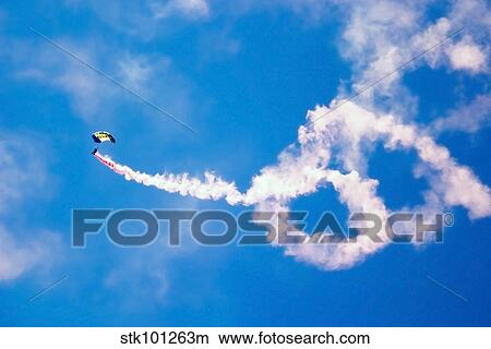 A U. S. Navy Parachute Team Leap Frogs crewmember descends through the sky. View Large Photo Image Picture - A U. S. Navy Parachute Team Leap Frogs crewmember descends through the sky.. Fotosearch