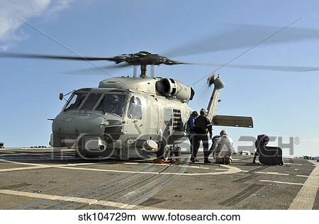 A U. S. Navy SH-60B Seahawk helicopter is refueled on the flight deck of USS Thach. View Large Photo Image Picture - A U. S. Navy SH-60B Seahawk helicopter is refueled on the flight deck of USS Thach.. Fotosearch