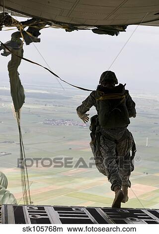 A U. S. soldier jumps out of a C-130J Super Hercules. View Large Photo Image Picture - A U. S. soldier jumps out of a C-130J Super Hercules.. Fotosearch