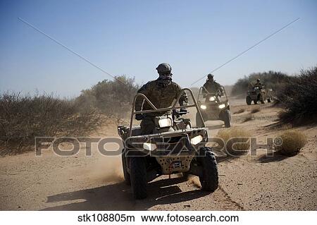 A U. S. Soldier performs off-road maneuvers with a LTATV. View Large Photo Image Picture - A U. S. Soldier performs off-road maneuvers with a LTATV.. Fotosearch